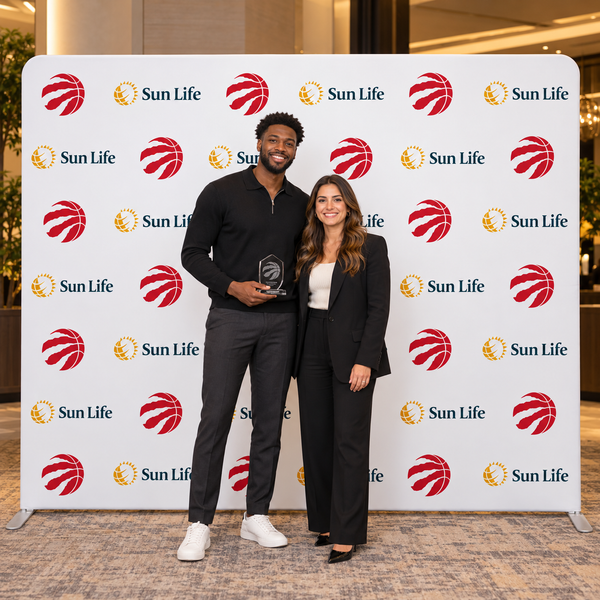 Illustrative event photo moment with Raptors and Sun Life step-and-repeat backwall artwork